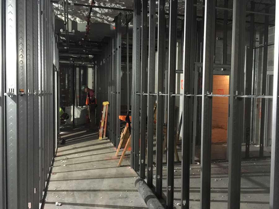 Sample photo: rows of steel studs and door frames.